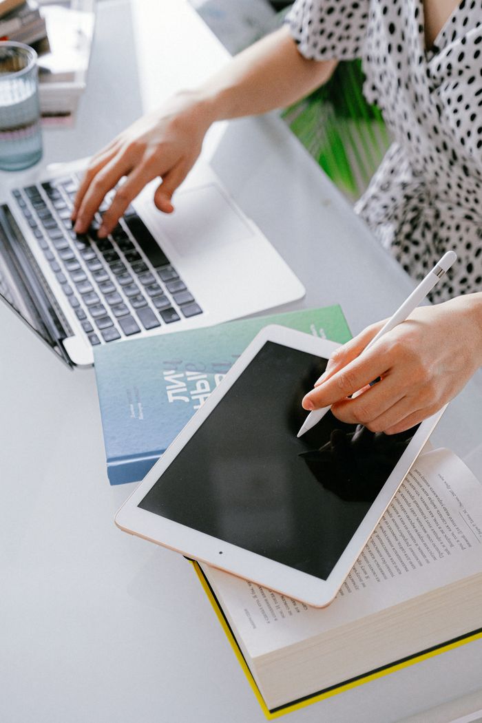 Mastering the First Impression: Your intriguing post title goes here A person working remotely with a laptop and tablet, illustrating digital nomad lifestyle and technology.