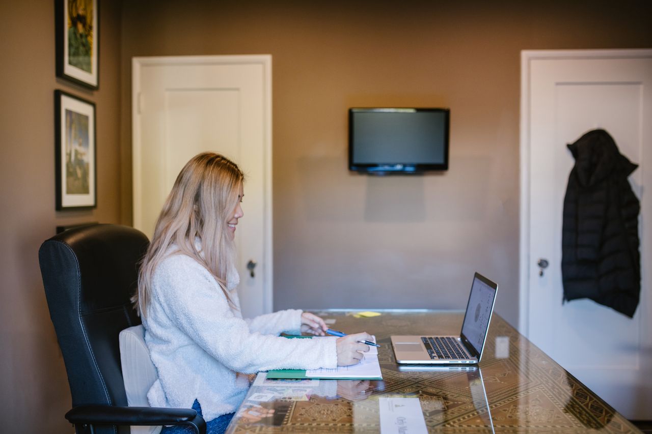 Crafting Captivating Headlines: Your awesome post title goes here Woman focused on laptop during remote work from home.